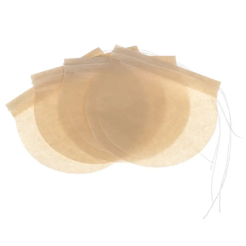 Hand tying drawstring on a disposable plant-fiber tea filter