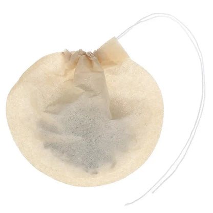 Biodegradable tea filter filled with dried herbs and spices for infusion