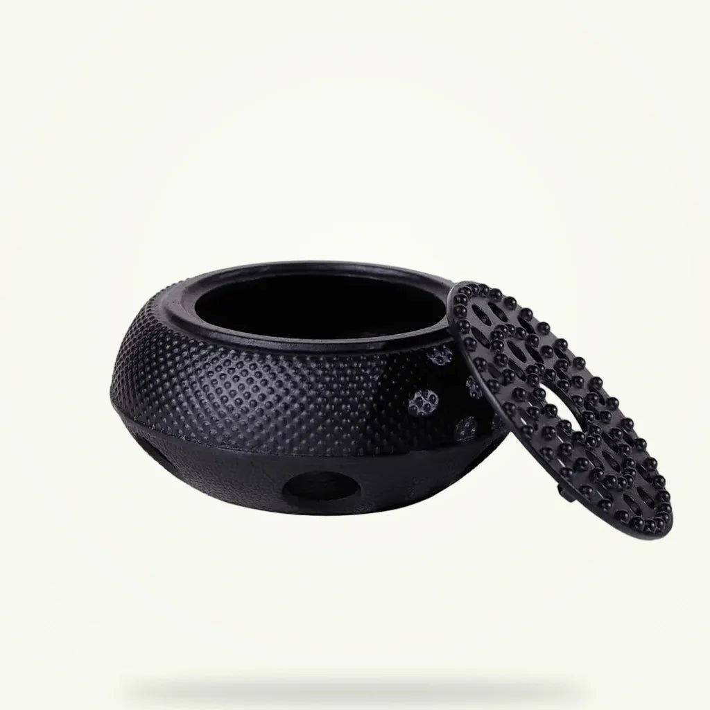 Black cast iron teapot warmer with ventilated design, full product view on plain background