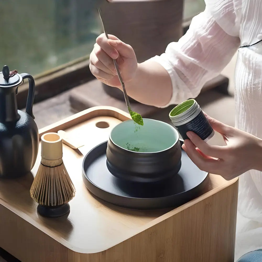 Black ceramic chawan matcha bowl front view on neutral surface