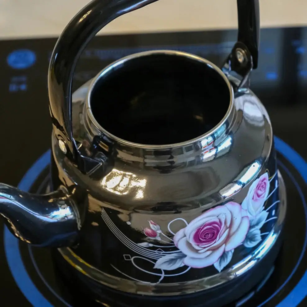 Black enamel teapot filled with tea