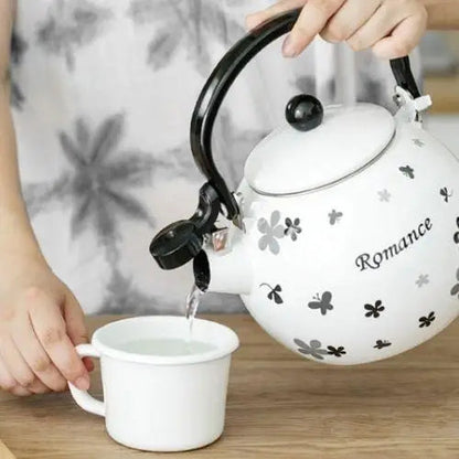 Black and white porcelain whistling teapot with butterfly design