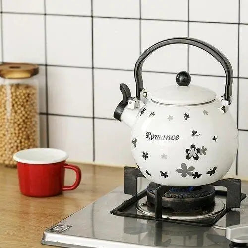 Porcelain whistling teapot on gas stove