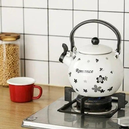 Porcelain whistling teapot on gas stove