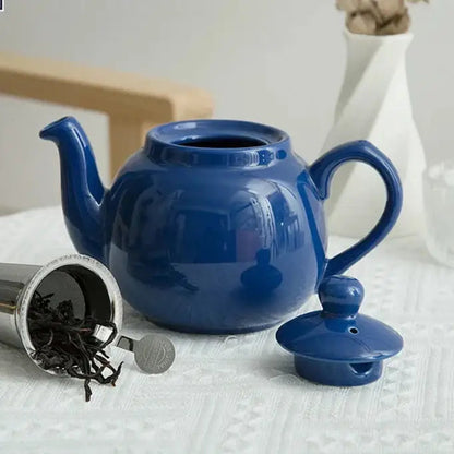 Blue ceramic teapot on wooden table