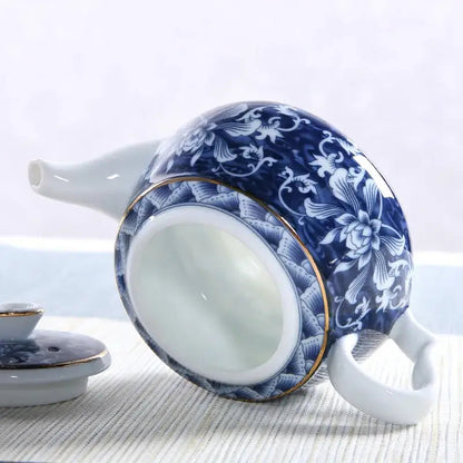Blue ceramic teapot with cup of tea