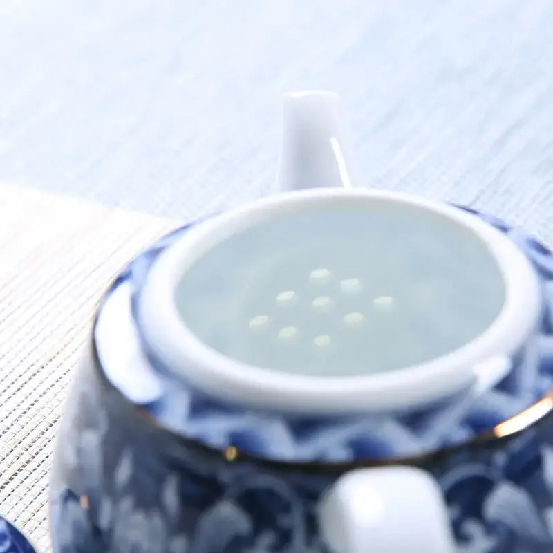 Blue ceramic teapot with spout and handle