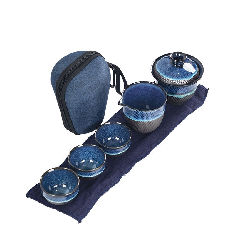 Blue enameled Chinese teapot with gaiwan set on Scandinavian wooden table