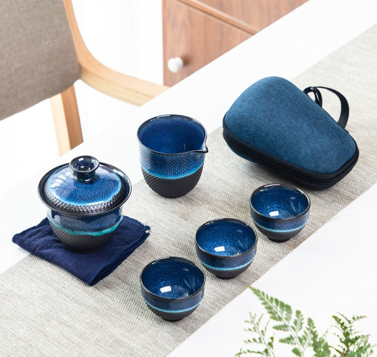 Blue enameled teapot and gaiwan with loose-leaf tea ready to brew