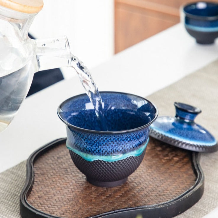 Blue enameled teapot on kitchen shelf with cozy Scandinavian-style background