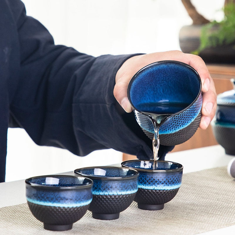 Blue enameled teapot with gaiwan on tray, ready for loose-leaf tea session