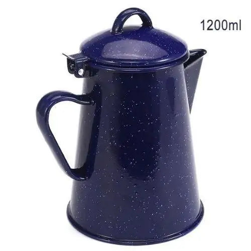 Blue star ceramic tea kettle on wooden table next to filled tea cup