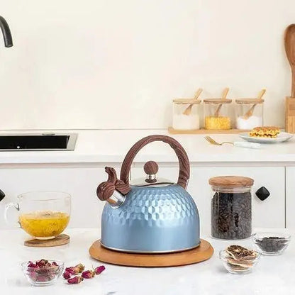 Blue whistling tea kettle on stove with steam
