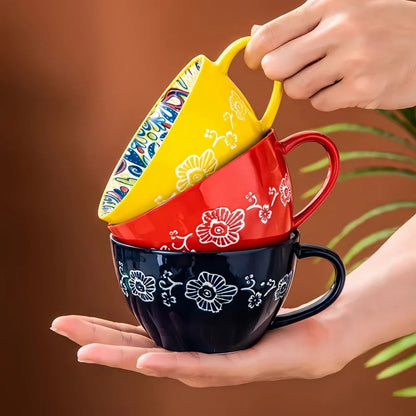 Bohemian ceramic mug front view with thick handle and folk art decoration