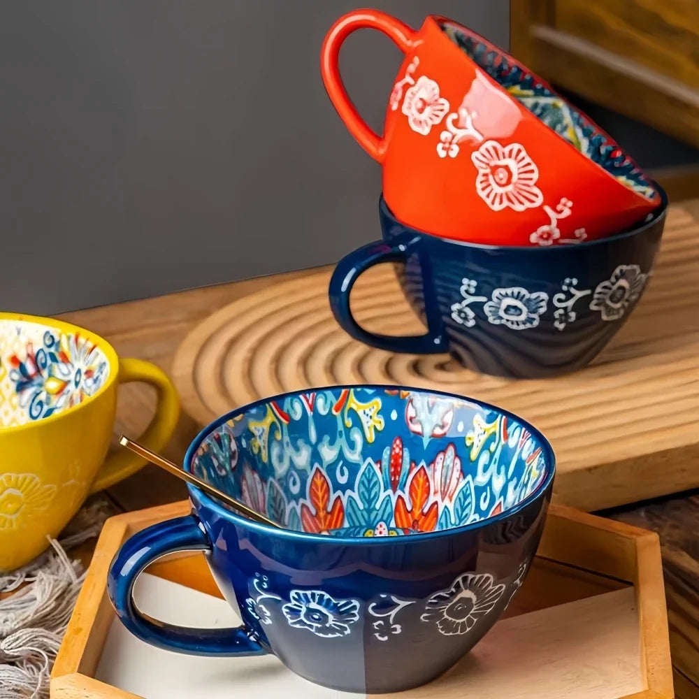 Hand-painted bohemian ceramic tea mug showing colorful pattern detail