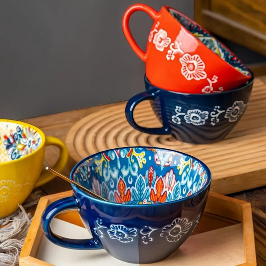 Hand-painted bohemian ceramic tea mug showing colorful pattern detail
