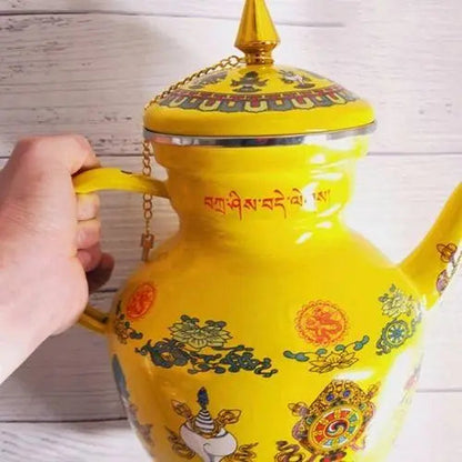 Enameled Buddhist tea kettle in use on a gas stove burner