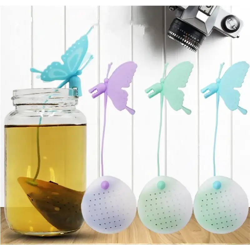 Butterfly tea infuser with loose tea leaves nearby