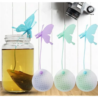 Butterfly tea infuser with loose tea leaves nearby