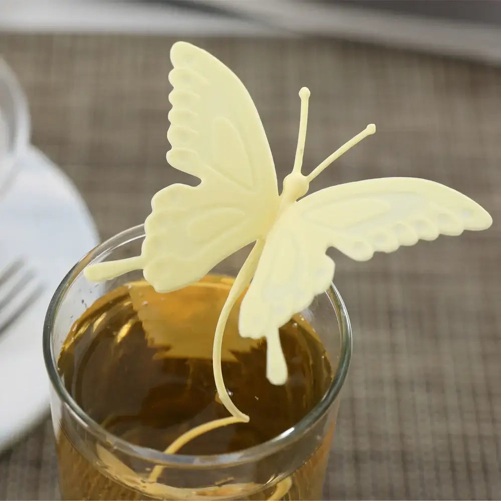 Yellow butterfly tea infuser on a saucer