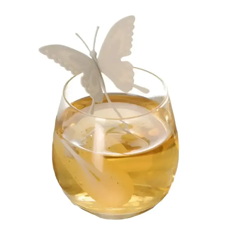 Gray butterfly tea infuser with steam rising from a cup