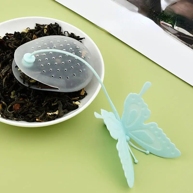 Blue butterfly tea infuser on a wooden table