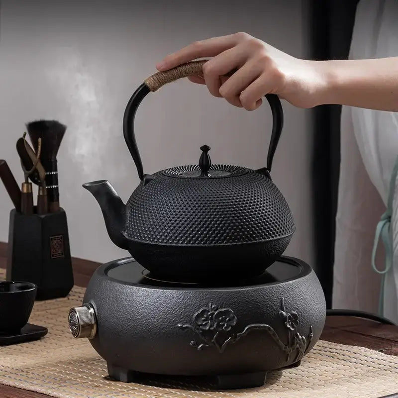 Induction-compatible cast iron teapot showing textured body detail and flat base