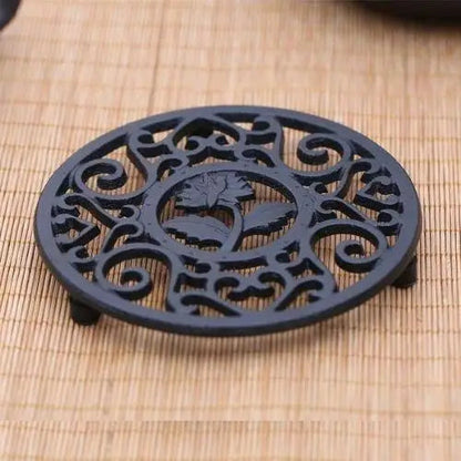 Teapot resting on cast iron trivet with steam