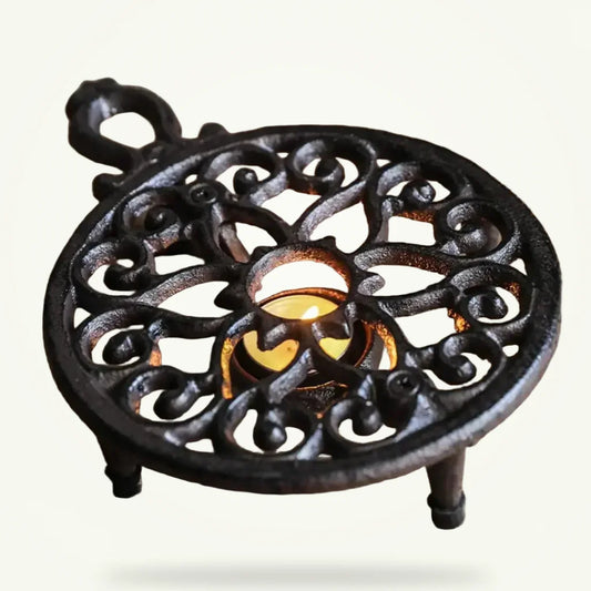 Cast iron teapot warmer with hand-forged wrought iron stand, full product view on white background