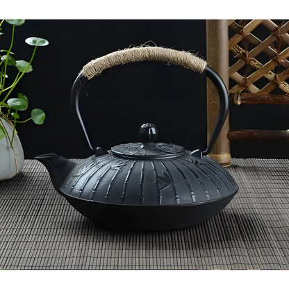 Cast iron teapot with bamboo motif side view showing hand-etched pattern detail