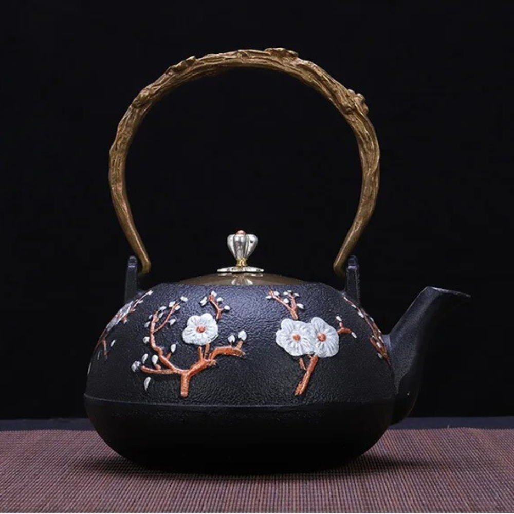 Close-up of cast iron teapot lid with bird-shaped knob, enamel finish detail