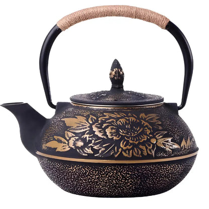 Black enameled cast iron teapot with raised golden flower design