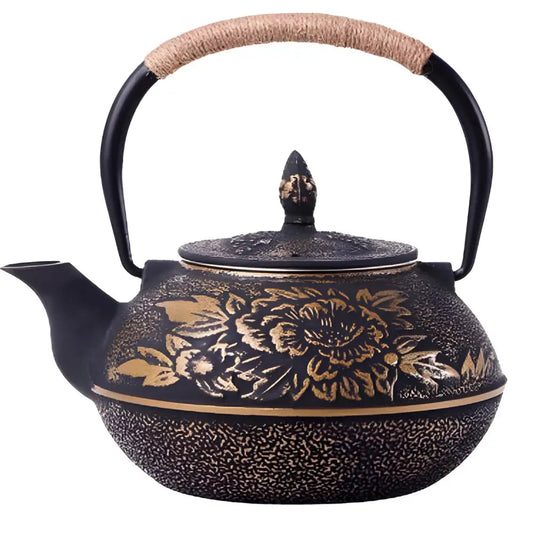 Black enameled cast iron teapot with raised golden flower design