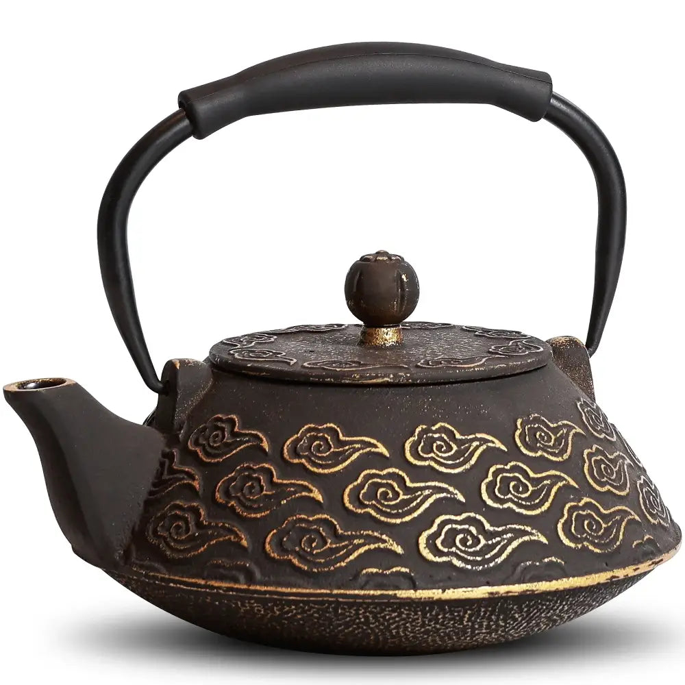 Black cast iron teapot with infuser on wooden table