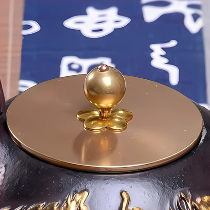 Cast iron teapot with gold accents, elegant display