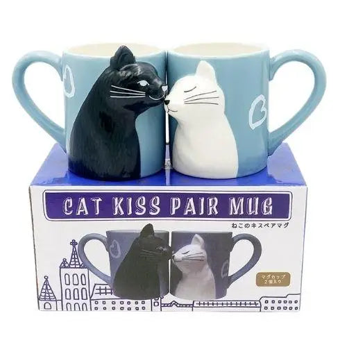 Black and white cat mugs displayed together on kitchen shelf