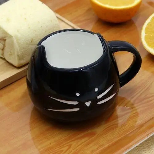 Black cat mustache tea cup on table