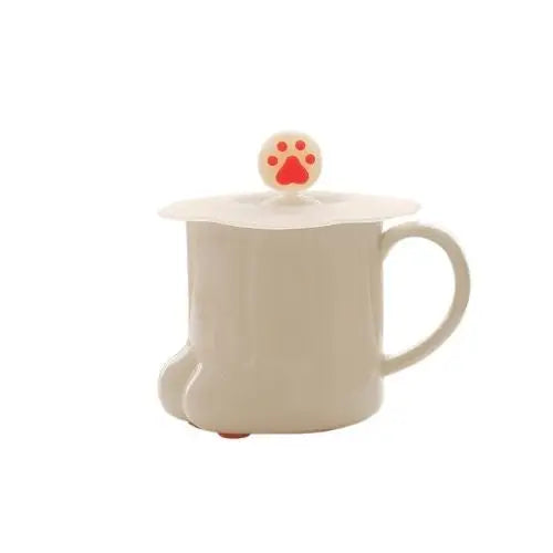 White cat paw tea cup with black paw pad markings and porcelain lid