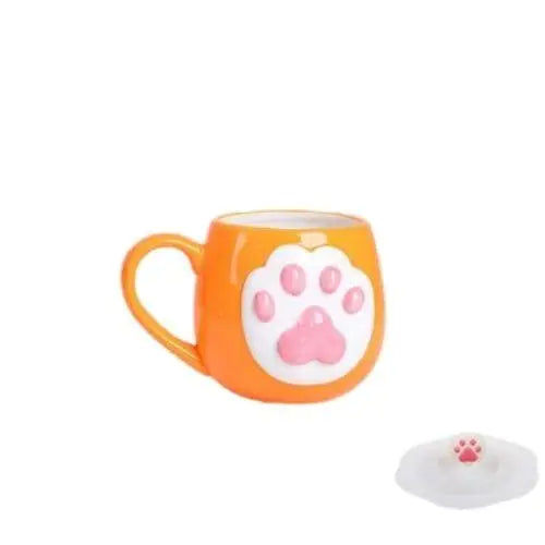 Orange-toned cat paw tea cup with white paw pads and matching lid