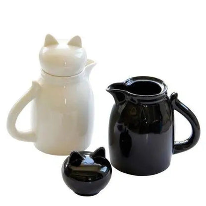 Two cat teapots in white and black