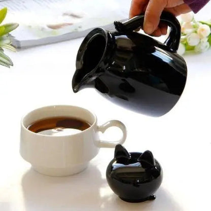 Pouring tea from cat teapot into cup