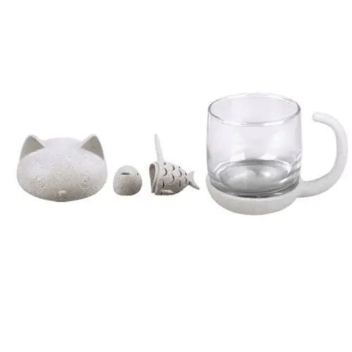 Glass cat cup components laid out, cup lid and infuser shown
