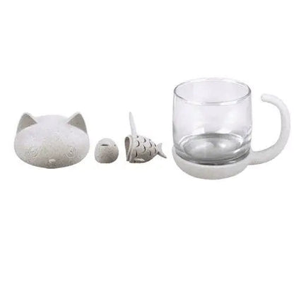 Glass cat cup components laid out, cup lid and infuser shown