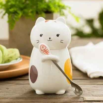 Cat tea mug with spoon resting on saucer