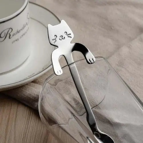 Stainless steel cat teaspoon with cat-shaped handle on white background