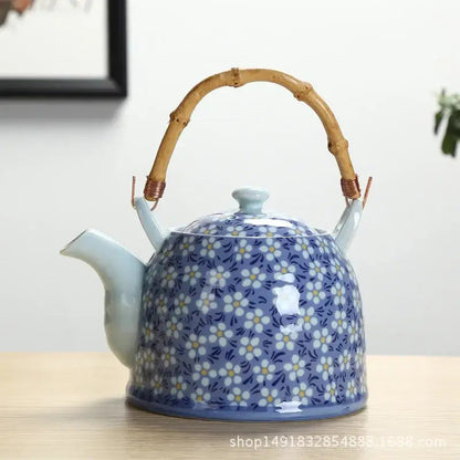 Blue ceramic flower teapot on table