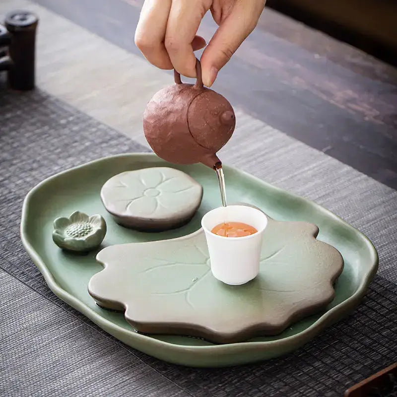 Ceramic leaf tea tray in green on a wooden table