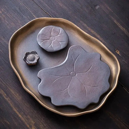 Brown ceramic leaf tea tray on a table