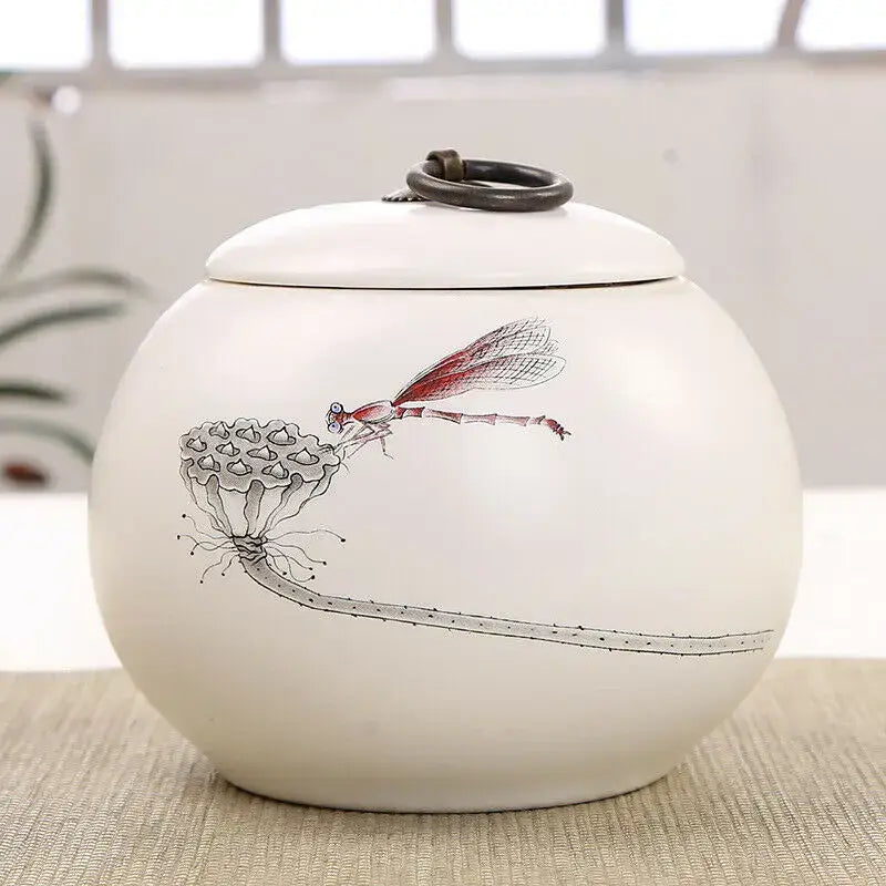 Matte white ceramic tea canister with dragonfly design and airtight lid