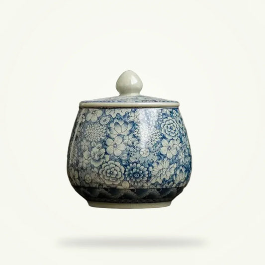 Ceramic tea canister with fitted lid, hand-painted China ancestral blue-and-white design, plain background